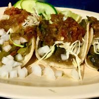 From left to right, Peppers, cactus, and two mushroom tacos topped with the fixings. at Taquería Los Arbolitos in San Francisco