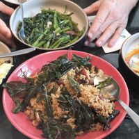 Pork belly fried rice and morning glory. Half eaten wing bean salad and chicken salad at Baanying's Plant-Based Ying's Garden  in Bangkok