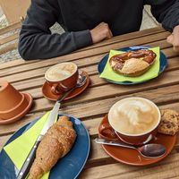 Capuccino with oatmilk, vegan butter bretzel and vegan croissant at Coffee & Panini in Ulm
