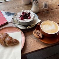 Vegan Croissant filled with jam, granola with coconut yoghurt and berries and oat cappuccino  at Coffee & Panini in Ulm