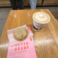Vanilla oat milk latte and tahini chocolate chip cookie  at Seven Grams Caffé in New York City