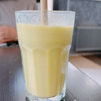 smootie de mango con jugo de paquete de naranja   at Encanto - Art Cafe in Helsinki