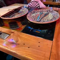 Table with inlaid archaic cell phones  at Tymi in Tirana