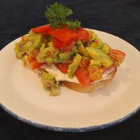 Menu Description: Smashed Avocado, roasted peppers, vegan cream cheese & sliced tomato on toasted sourdough at The Pantry in Reading