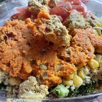 My kale/avocado salad topped with vegan carrot tuna, battered cauliflower, sweet coconut corn, quinoa, mushrooms, and other things I don’t recall.   at Tassili's Raw Reality in Atlanta