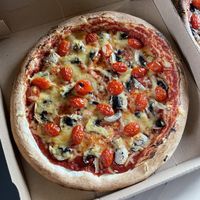 Mushroom and cherry tomato pizza with violife vegan cheese!  at Plaisirs Pizzas in La Bresse