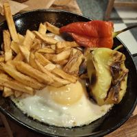 Eggs, fries and grilled peppers at Fogar do Santiso in Santiago De Compostela