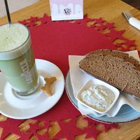 Matcha latte and homemade bread with spread at Mary's Café Lounge in Neuburg An Der Donau