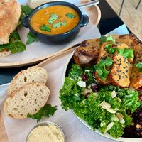 Deerbrook sandwich + lentil soup combo on top, Blue Zone bowl with tempeh & side salads (and bread and hummus) on bottom at Deerbrook Kitchen in Koenigstein