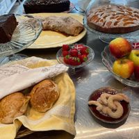 A selection of the café's baked goods - bread rolls, appel strudel, apricot cake, and a special Austrian chocolate cake with marmalade filling at Café Hyggestund' in Birkeroed