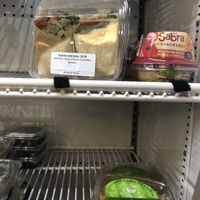 Grab and go section: includes hummus wrap (sometimes), hummus, and peanut lime noodles  at Manndible Cafe in Ithaca