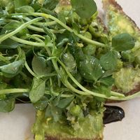 pea and greens on avocado toast w/lemon very good, summer seasonal option  at Nemesis in North Vancouver