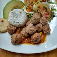 Fried soy nuggets tiny arepa white rice with mustard seeds and a salad at Vegarden in Medellin