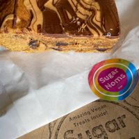 Peanut butter and chocolate chip cookie bar was incredible.  Had half cold and half warm. Both perfect with a coffee    at Sugar Noms in Redcar