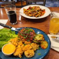 Both entrées are from their seasonal specials: roasted cauliflower with spicy Korean sauce with sticky rice balls and kimchee and a roasted squash Buddha bowl with seitan at Home Grown Cafe in Newark