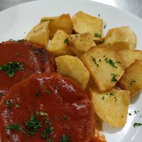 Filetes rusos veganos con salsa de tomate y patatas fritas at La Regina Restaurante in Madrid