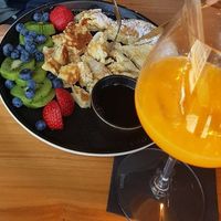 Pancakes with maple sirup and fresh orange juice, . at IVY Tagesbar in Munich