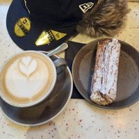 Cappuccino et croissant aux amandes at WAY Plant Based Bake House in Ghent