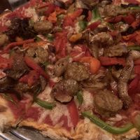 Vegan pizza with Smart Sausage, green peppers, roasted red peppers, caramelized  onions, vegan cheese!  at Pizzetta in Mystic