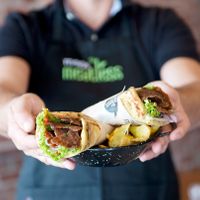 Wrapped pita with vegan yeeros, vegetables and humus at Kokos Pitta in Patras