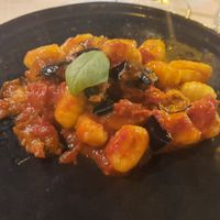 Fresh gnocchi with tomato and eggplant sauce. Yummy! (Half portion) at Carnalmente in Assisi