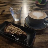 Chocolate hazelnut cake and latte at Ortica Italian Plant Based in Urmston