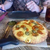 Tomato and olive focaccia with basil pesto   at Ortica Italian Plant Based in Urmston