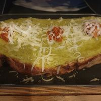 Bruschetta Fave & N'duja: Broad bean purée, spicy N'duja, grated parmesan cheese, evoo at Ortica Italian Plant Based in Urmston