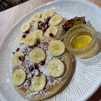 Pancakes with banana, maple syrup and powdered sugar. at Mundi Café in Charneca Da Caparica