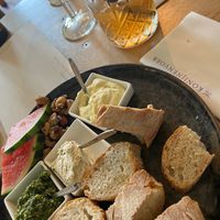 Lemon butter, Shallots sauce, Pesto served with sour dough bread, watermelon, caramelised cashews at Konijnenvoer in Arnhem