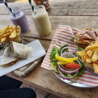 Cauliflower hash wrap, nacho bean burger, banana blueberry oat smoothie and banana, mango, pineapple and chia seed smoothie  at AJ's Kitchen in Telford