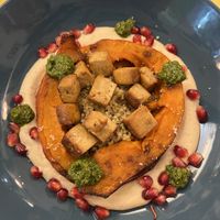Courge rôtie, tofu, quinoa, hoummous, grenade, sauce chimichuri   at Le Jardin in Biarritz