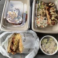 Tuna sandwich, pesto pasta salad, chili dog plate, and loaded red yams. at Veggie Grill by Next Level in Beaverton