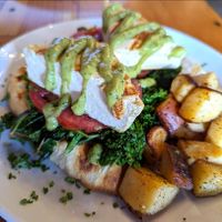 Grilled Tofu Benedict with sauteed kale, grilled tomatoes, avocado hollandaise, grilled bread and breakfast potatoes at The Cafe in Key West