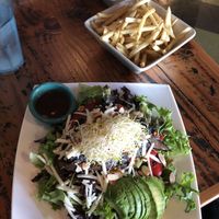 Portobello salad and a generous portion of the crispiest fries around. at The Cafe in Key West