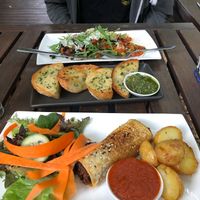 Pesto bread, stuffed sweet potato, and vegan sausage roll at Bamboo Buddha in Holgate
