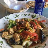tempeh veggie stir fry over penne with a black bean, rice, plantain, mango quesadilla in the background   at Bella Vida Cafe in West Cape May