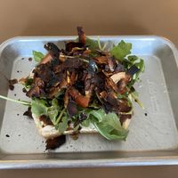 The Wellsbuilt Toast- Coconut bac'n, tomato, arugula, balsamic glaze, vegan mayonnaise, coarse salt & fresh-cracked pepper  at Easy Luck in Orlando