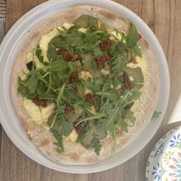 Pizza with sundried tomatoes, caramelised onions, mushroom, rocket, cheese   at Humus Vegan Tenerife in Tenerife