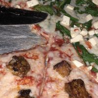 vegan pizza with tempeh on one side and tofu and spinach on the other at Mellow Mushroom in Birmingham