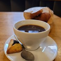 Prune pastry (vegan) with americano at Massolit Bakes in Krakow
