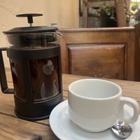 plunger coffee with oat milk  at Our Local  in Cape Town