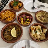 Small plates: Falafel, loubia (stewed beans), olives, hummus, zaalouk (aubergine), herby diced potatoes  at World Storytelling Cafe in Marrakech