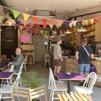 The cafe seating, with the street doors open on a lovely sunny day  at Baboo Gelato in Swanage