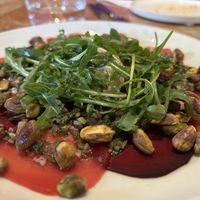 Rote Beete carpaccio mit Pistazien, Ruccola und Cashewcreme  at Chez Nina in Amsterdam