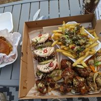 Chick'n satay burger, hoisin (seitan) duck bao buns, Korean chick'n wings, salt and pepper mushrooms and teriyaki broccoli dirty fries at Vegalution in Colchester