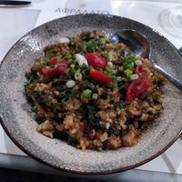 Cooked spinach with brown rice and cherry tomatoes. at Afrálato in Kalamata