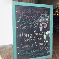 Sign on public sidewalk becoming vegans inside   at Calista in Antigua