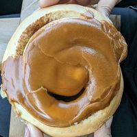 Huge caramel-topped cinnamon scroll at Brauðgerðarhús Akureyrar in Akureyri