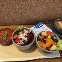 Selection of beans, porridge, fruit salad and a coffee at Pantry Brunch & Coffee in Budapest